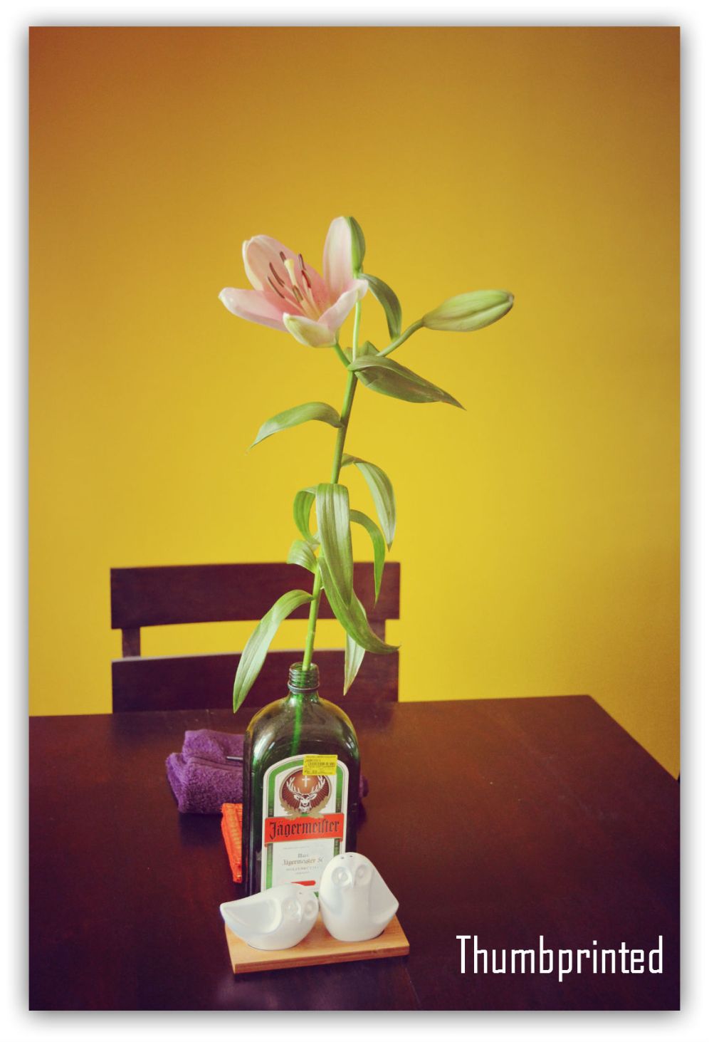 Recycled bottle vase and flowers, a constant on our dining table